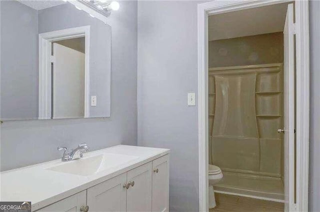 bathroom with hardwood / wood-style floors and vanity