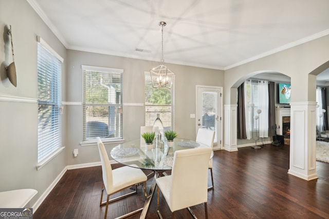 dining space with a chandelier, dark hardwood / wood-style floors, and crown molding