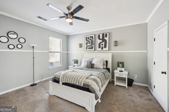 carpeted bedroom featuring ceiling fan and crown molding