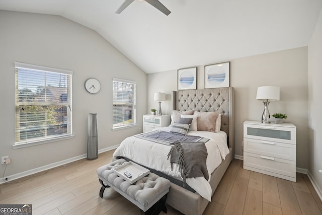 bedroom with multiple windows, ceiling fan, light hardwood / wood-style floors, and vaulted ceiling