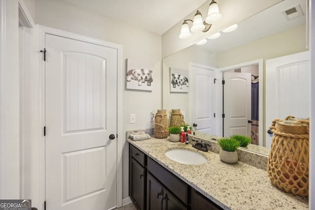 bathroom featuring vanity and an inviting chandelier