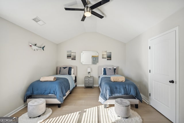 bedroom featuring ceiling fan, light wood-type flooring, and lofted ceiling