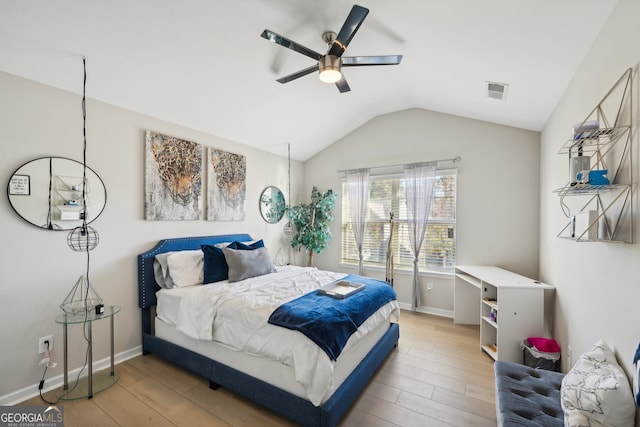 bedroom featuring ceiling fan, hardwood / wood-style floors, and lofted ceiling