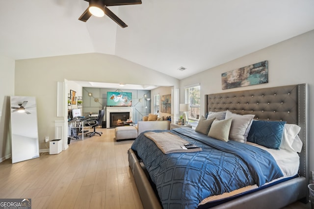 bedroom featuring hardwood / wood-style floors, ceiling fan, and lofted ceiling