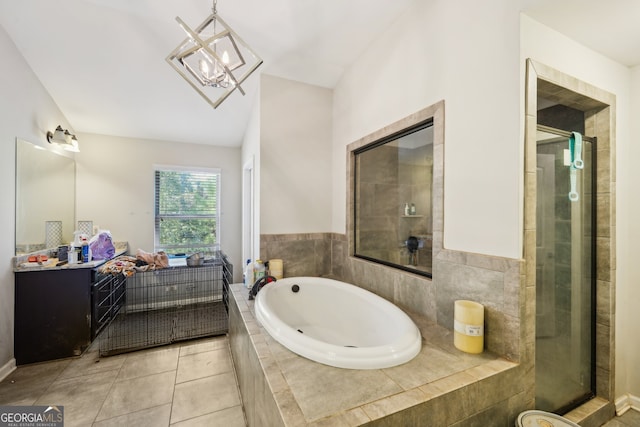 bathroom with tile patterned flooring, vanity, shower with separate bathtub, and vaulted ceiling