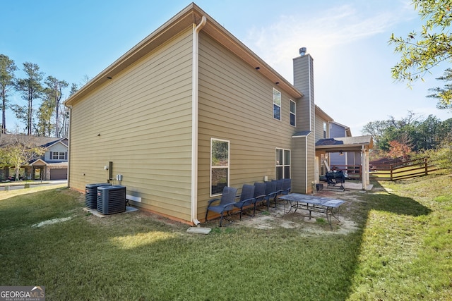 back of property featuring a lawn, an outdoor hangout area, a patio area, and central air condition unit