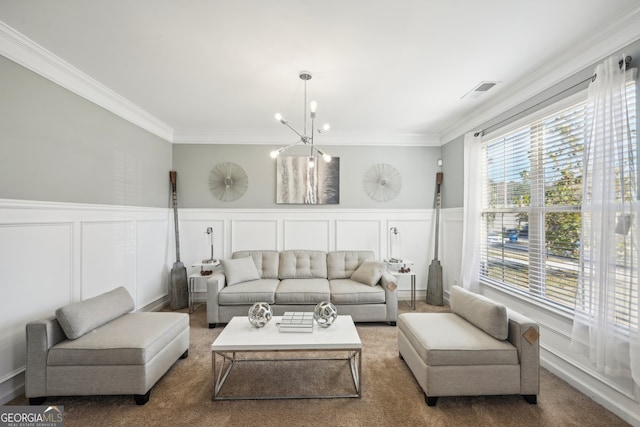 living room featuring a chandelier, carpet floors, and crown molding