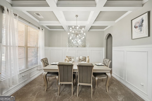 dining area featuring dark carpet, coffered ceiling, crown molding, a notable chandelier, and beam ceiling