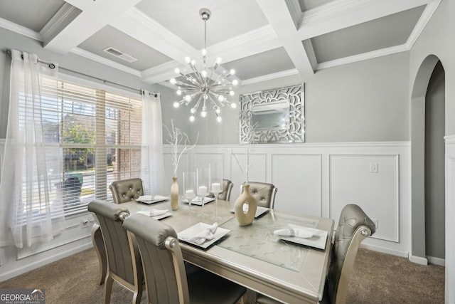 dining space featuring ornamental molding, coffered ceiling, beam ceiling, an inviting chandelier, and carpet floors