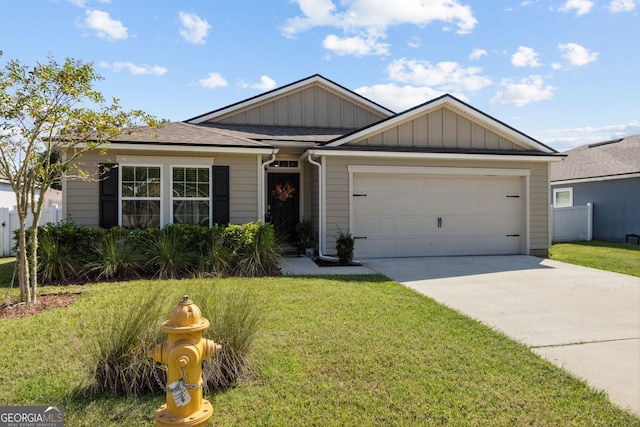 view of front of house with a front yard and a garage