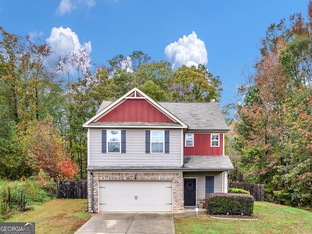 view of front of property featuring a front yard and a garage