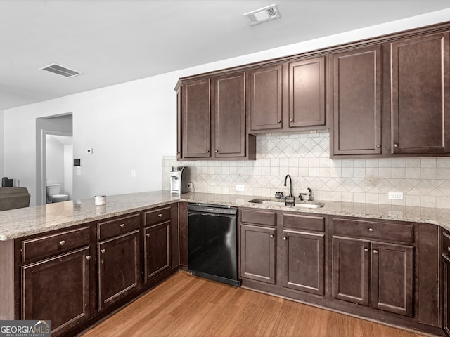 kitchen with dishwasher, kitchen peninsula, sink, light hardwood / wood-style flooring, and dark brown cabinetry