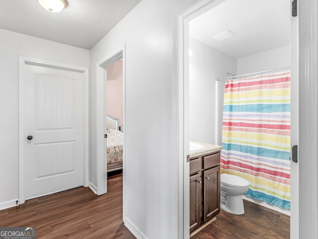 bathroom with vanity, toilet, wood-type flooring, and walk in shower