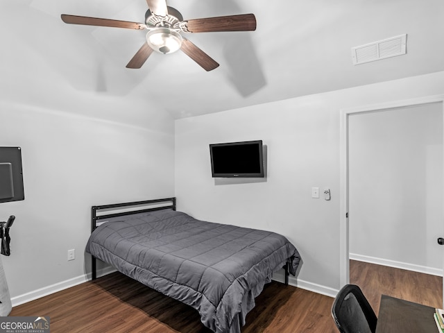 bedroom with dark hardwood / wood-style flooring, ceiling fan, and lofted ceiling