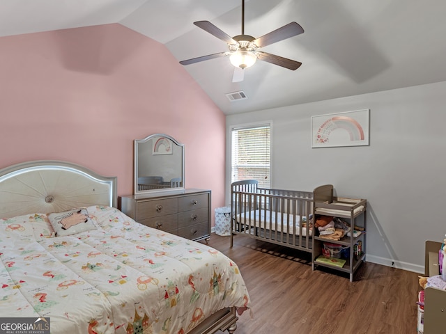 bedroom featuring ceiling fan, wood-type flooring, and vaulted ceiling