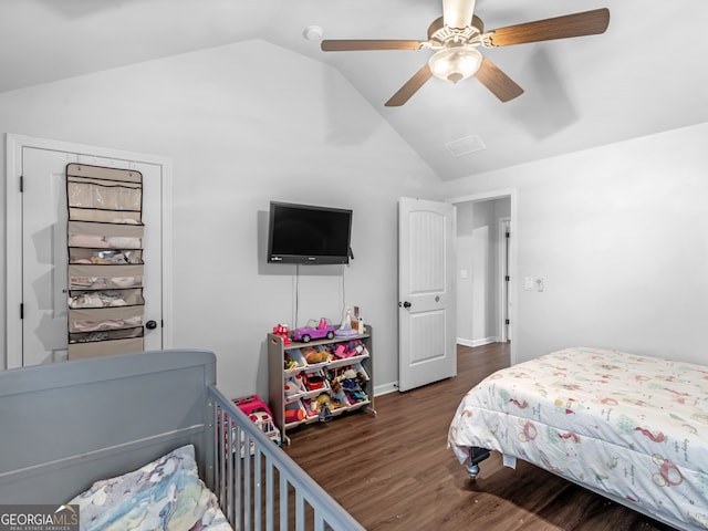 bedroom with ceiling fan, dark hardwood / wood-style floors, and vaulted ceiling