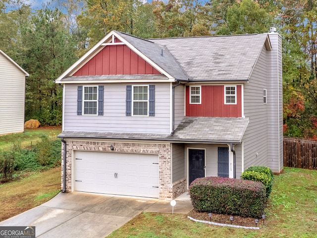 view of front of home with a garage and a front lawn