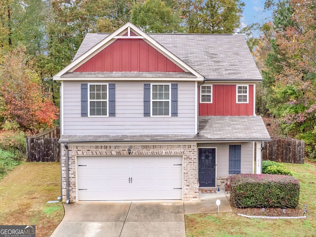 view of front of property featuring a front lawn and a garage