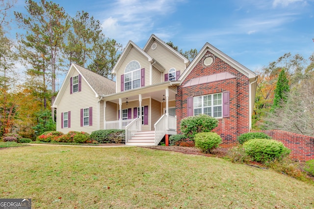 view of property with a front lawn and a porch