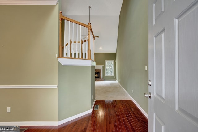 foyer featuring wood-type flooring and a fireplace