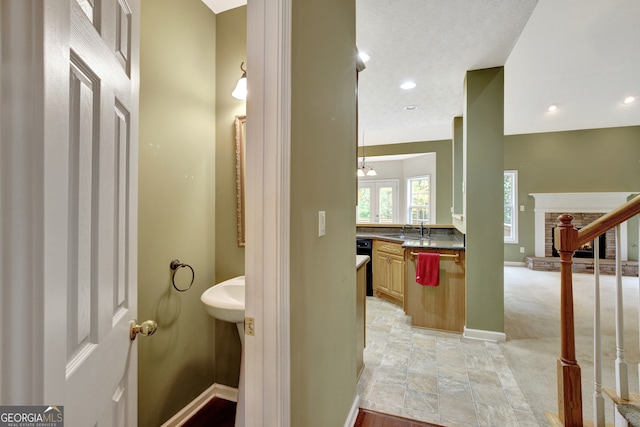 bathroom featuring a fireplace and sink