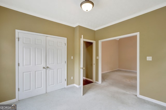 unfurnished bedroom featuring light carpet, a closet, and crown molding