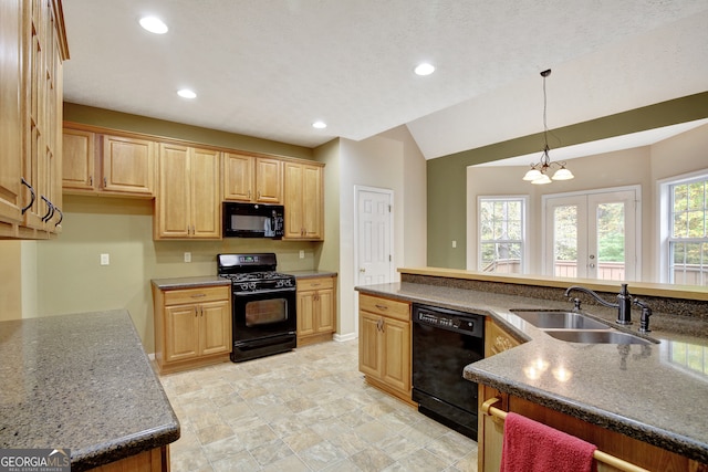 kitchen featuring black appliances, lofted ceiling, sink, and a wealth of natural light