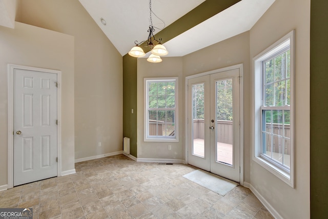 doorway to outside featuring plenty of natural light, lofted ceiling, french doors, and a chandelier