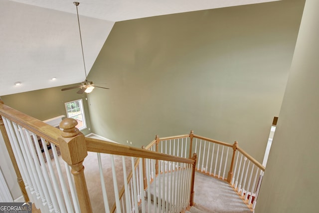 stairs featuring carpet, ceiling fan, and high vaulted ceiling