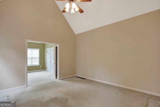 unfurnished room with ceiling fan, light carpet, and high vaulted ceiling