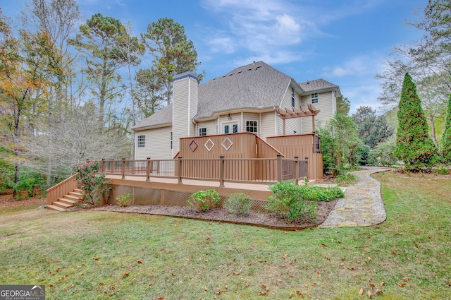 back of house with a wooden deck and a yard