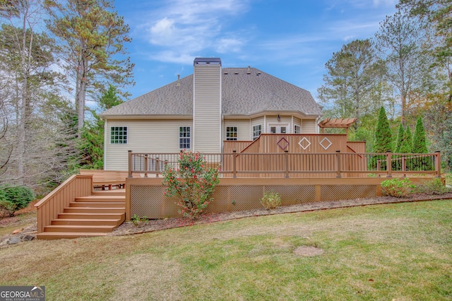 back of house with a yard and a wooden deck