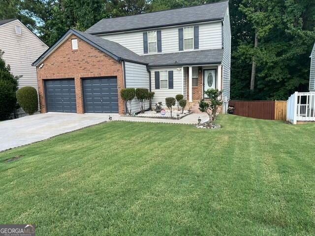 front facade with a garage and a front lawn