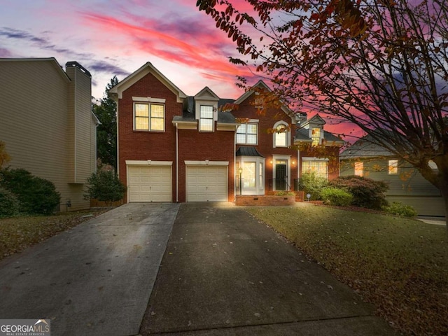 view of front of house featuring a lawn and a garage