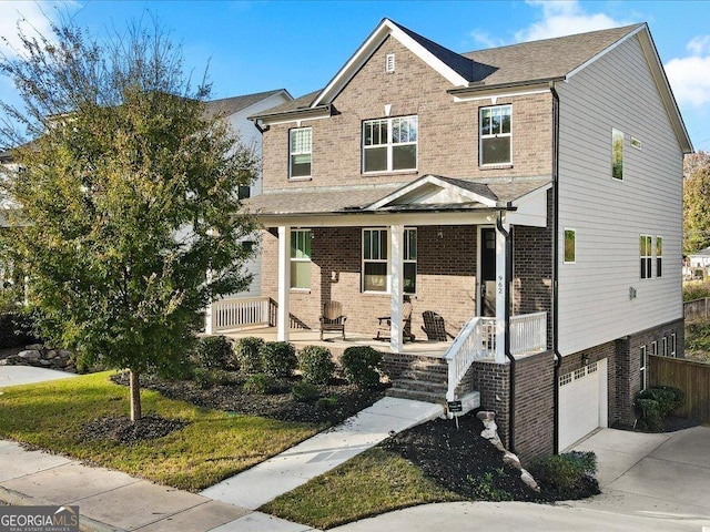 view of front of property featuring a porch and a garage