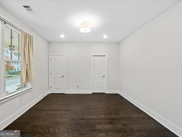 spare room featuring dark wood-type flooring