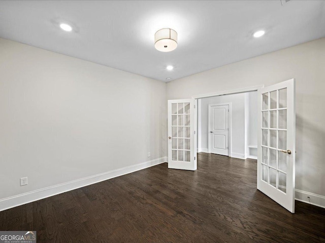 unfurnished room featuring dark hardwood / wood-style floors and french doors