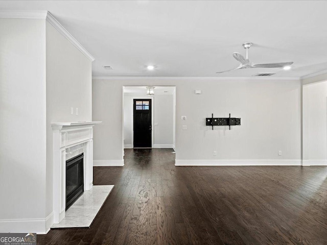 unfurnished living room with dark hardwood / wood-style flooring, ceiling fan, crown molding, and a premium fireplace