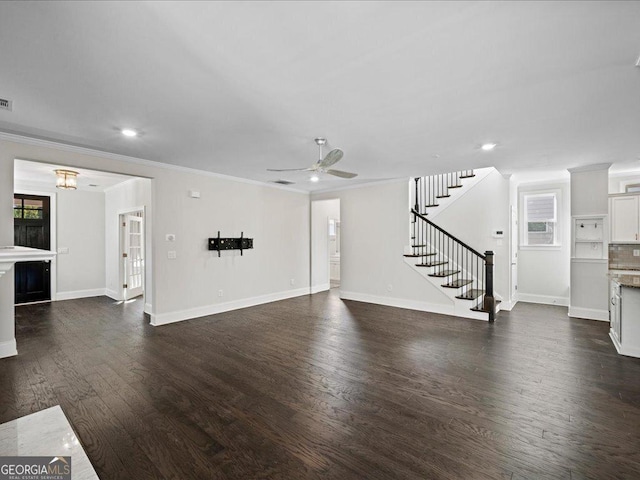 unfurnished living room featuring ceiling fan, dark hardwood / wood-style flooring, and ornamental molding