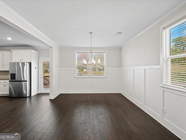 unfurnished dining area with a notable chandelier, crown molding, and dark wood-type flooring