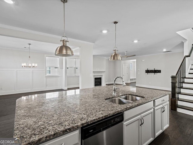 kitchen with white cabinets, a kitchen island with sink, sink, stone countertops, and dishwasher