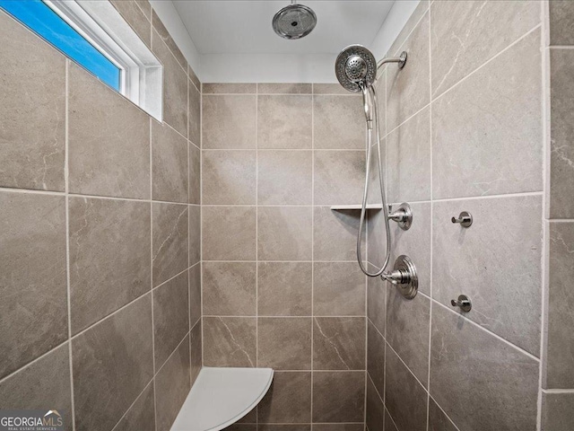 bathroom with tiled shower