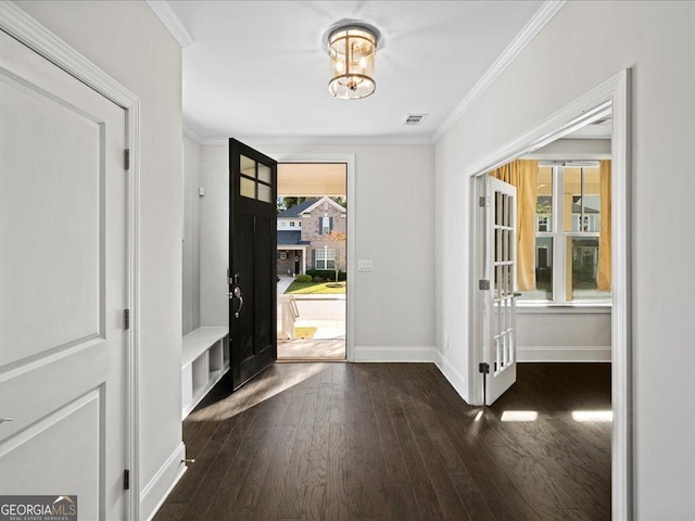 entrance foyer featuring dark hardwood / wood-style flooring and crown molding