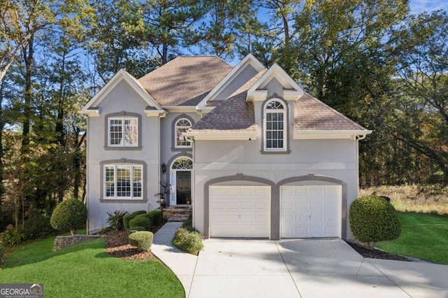 view of front of home with a front lawn and a garage