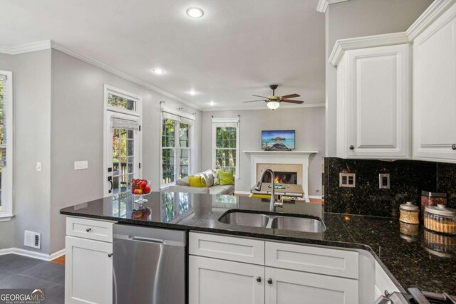 kitchen featuring white cabinets, dishwasher, dark stone countertops, and sink