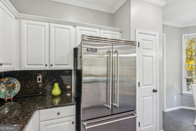 kitchen with white cabinets, ornamental molding, plenty of natural light, and built in fridge