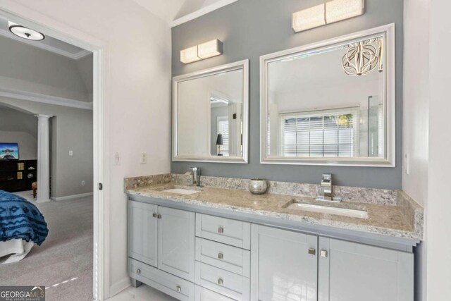 bathroom featuring vanity, ornamental molding, and decorative columns