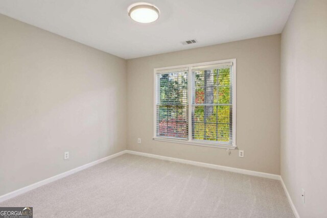 unfurnished room with carpet flooring