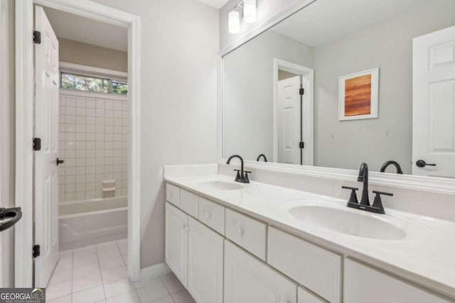 bathroom featuring tile patterned flooring, vanity, and tiled shower / bath