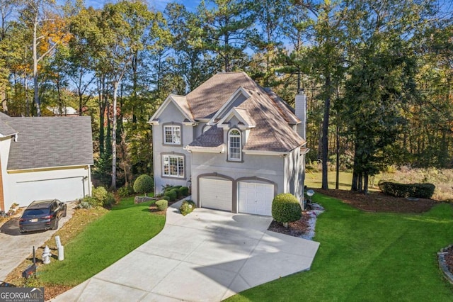 view of front facade with a garage and a front lawn